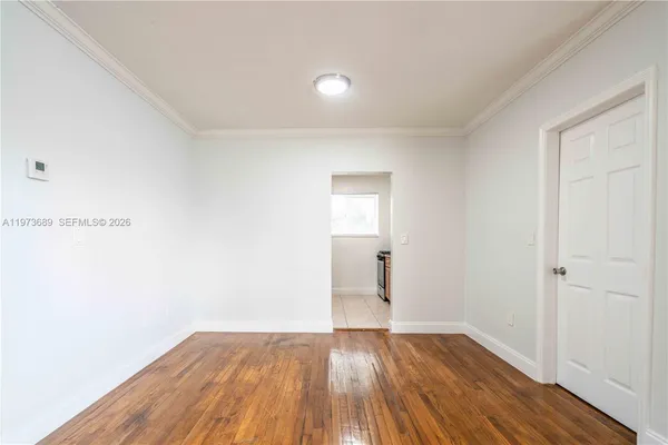 a view of wooden floor and windows in a room