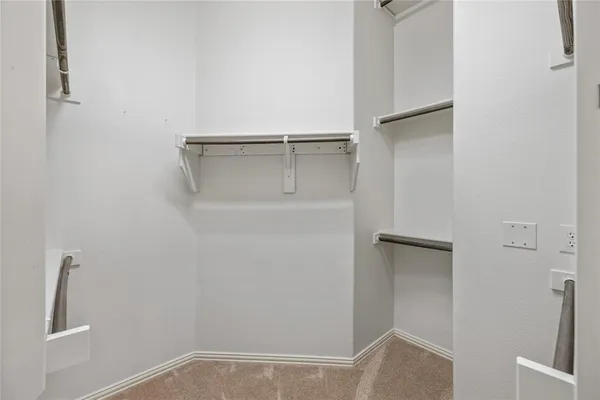 an empty room with a chandelier fan