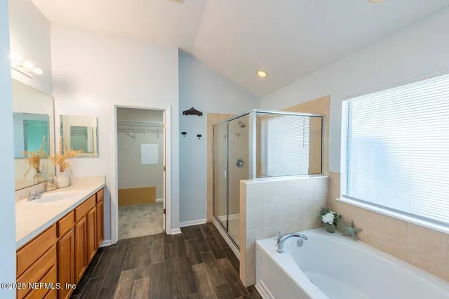 a bathroom with a tub sink and mirror