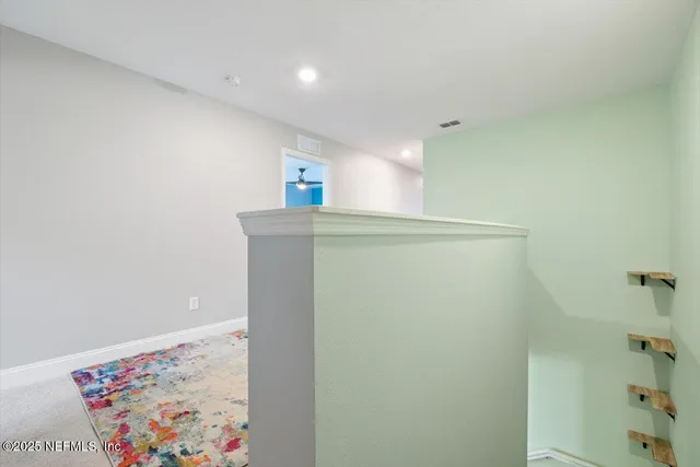 a very nice looking room with a chair and a potted plant