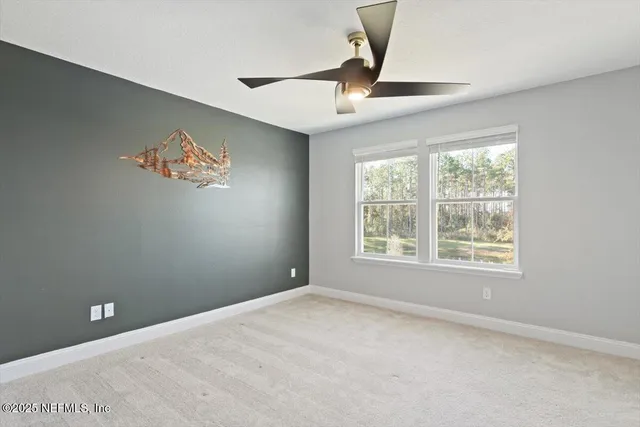 an empty room with windows and cabinet
