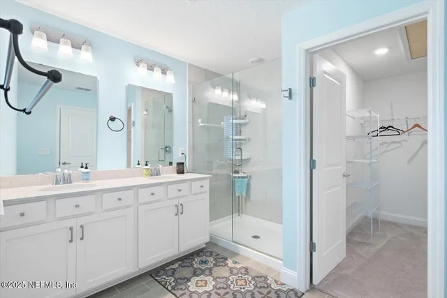 a spacious bathroom with a toilet sink and mirror