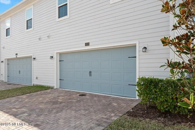 a view of a house with a yard and garage