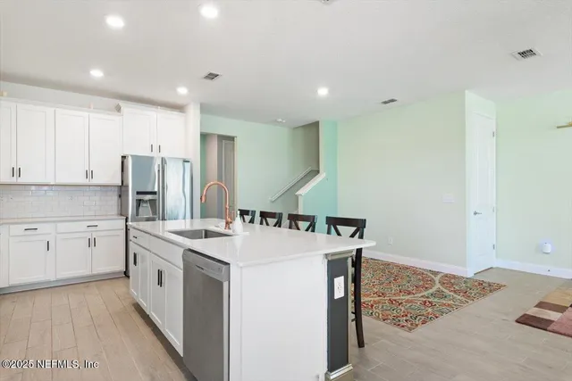 a kitchen that has a sink and a stove in it