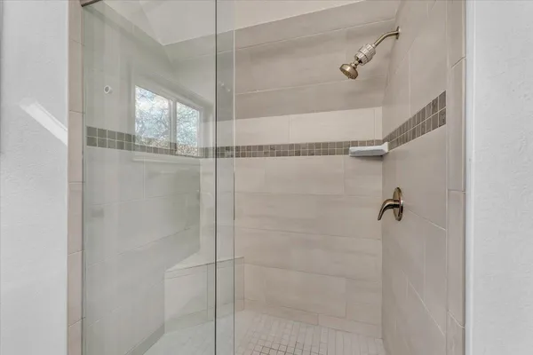 a bathroom with a glass shower door