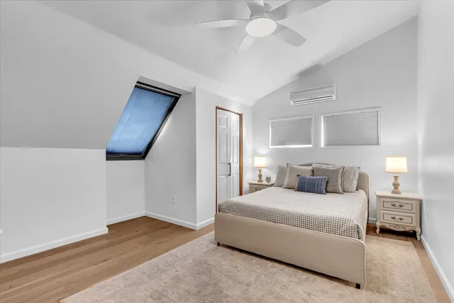 a spacious bedroom with a bed and a chandelier