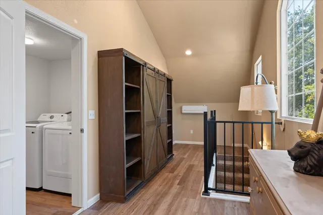 a view of hallway with furniture and wooden floor