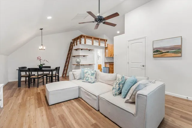 a living room with furniture and wooden floor