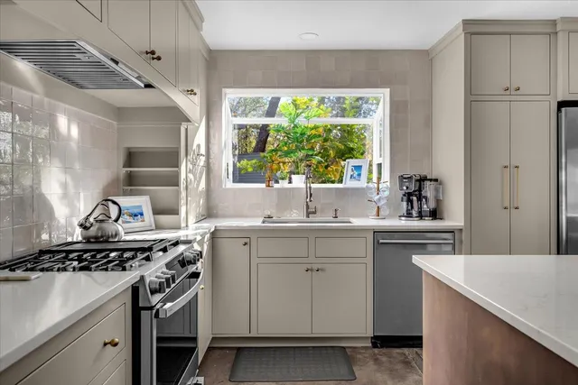 a kitchen with a stove and a sink