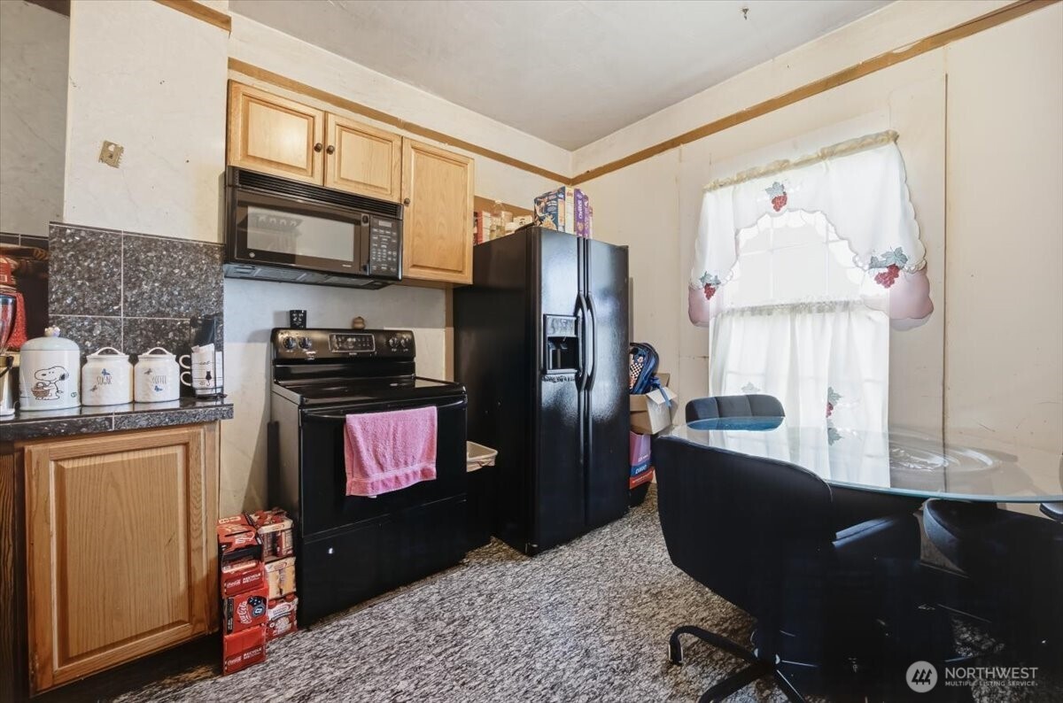 802 South 11th Avenue Pasco, WA 99301 - Photo 4 of 24 a kitchen with stainless steel appliances granite countertop a refrigerator stove top oven a sink and dishwasher