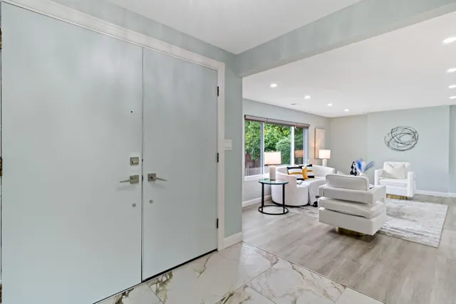 a large kitchen with stainless steel appliances lots of counter space and a sink