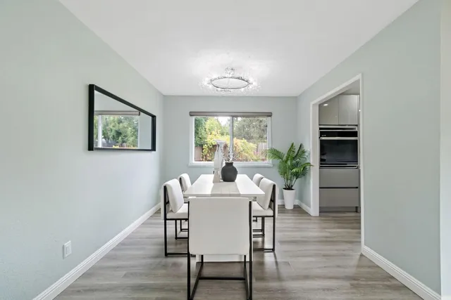 a bedroom with a bed lamp and a large window with outer view