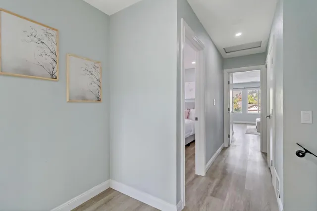 a front view of a house with a garden and trees