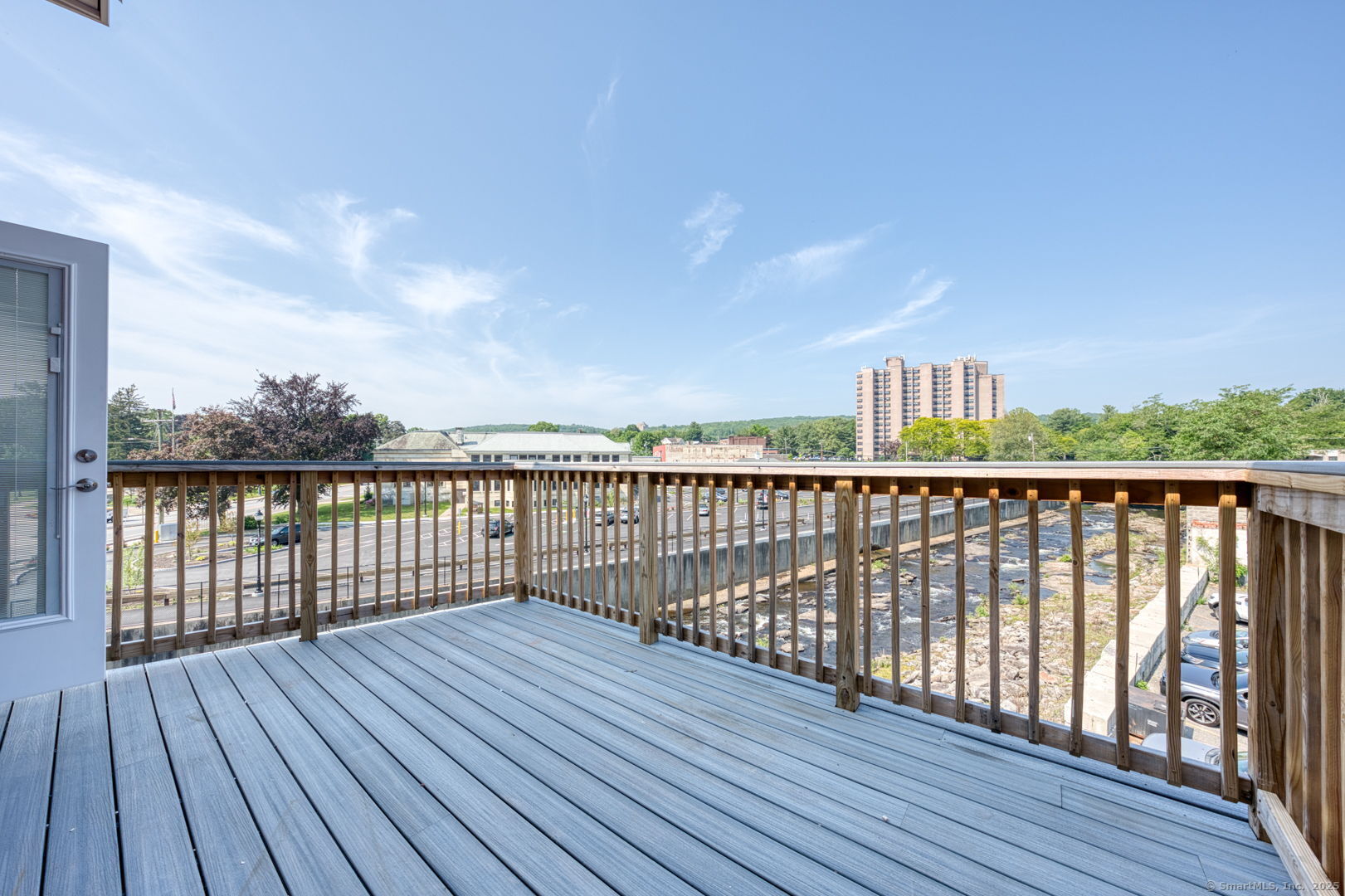 a balcony with wooden floor and fence