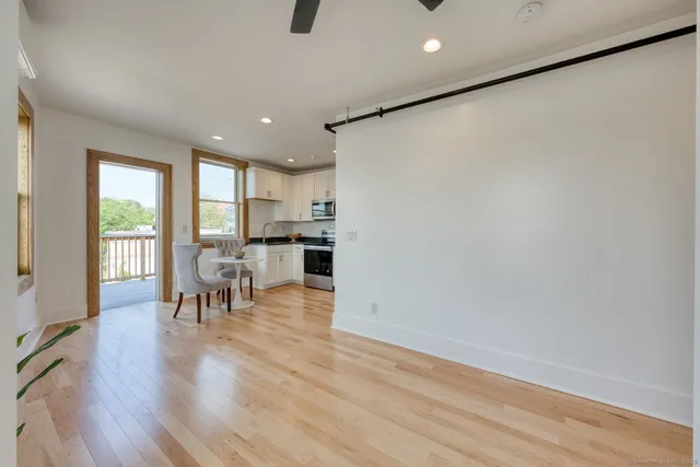a view of a dining room with furniture window and wooden floor