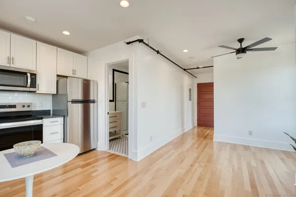 a kitchen with stainless steel appliances a refrigerator and a stove top oven