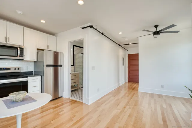a kitchen with stainless steel appliances a refrigerator and a stove top oven