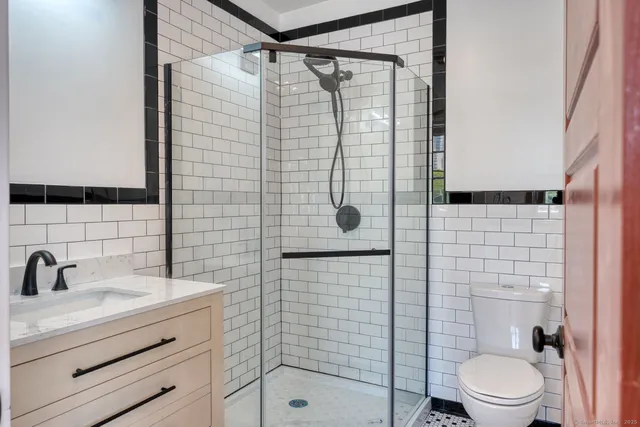 a bathroom with a shower toilet and sink