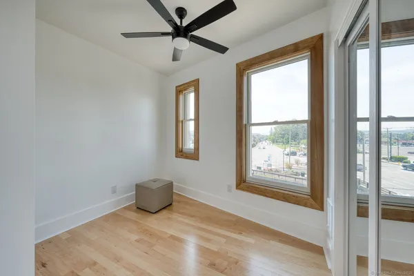 a view of a livingroom with a fireplace and a window
