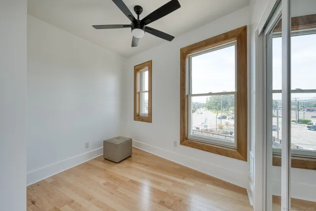 a view of a livingroom with a fireplace and a window