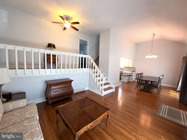a view of a livingroom with furniture wooden floor and a window