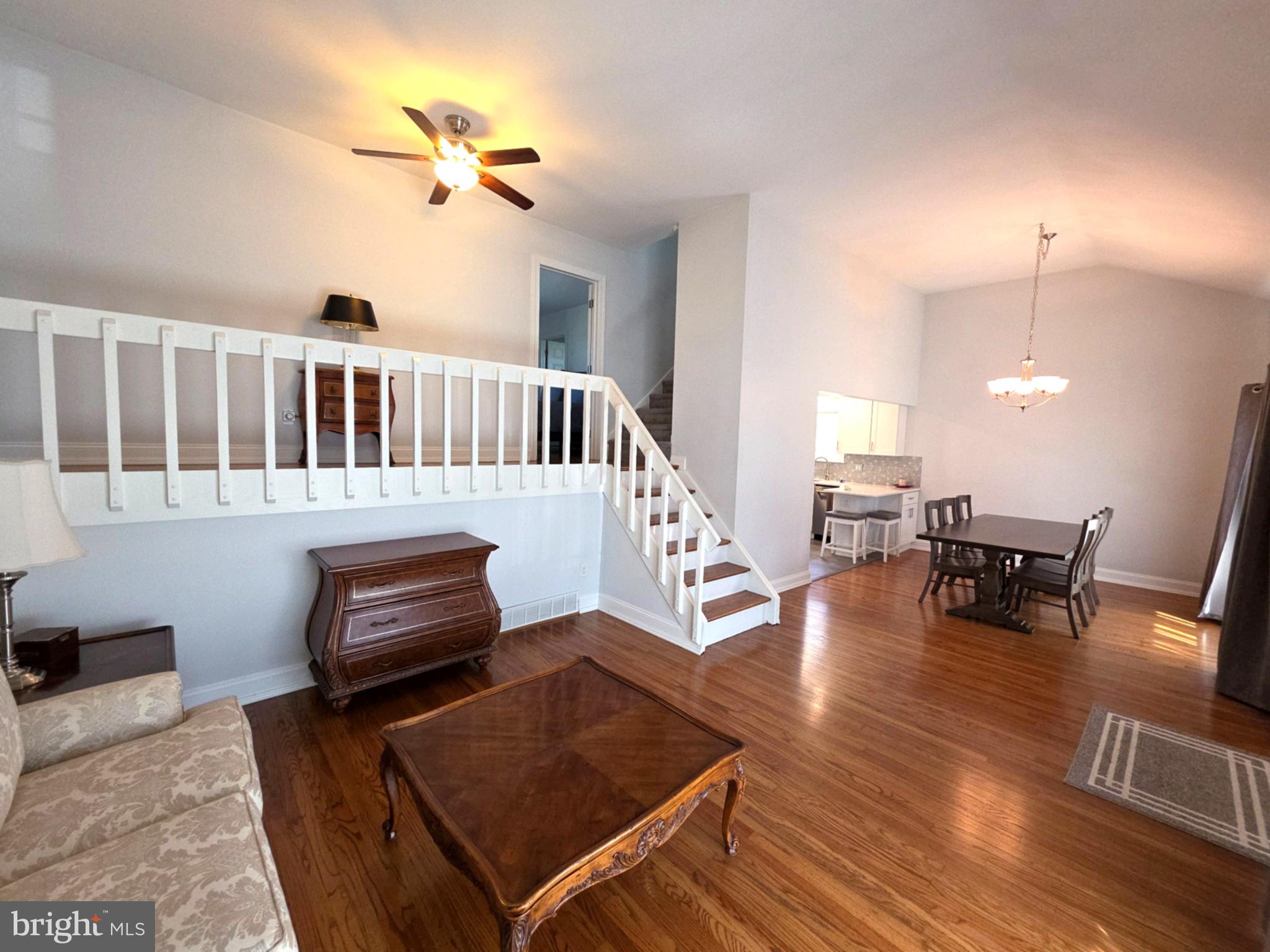 156 Crockett Road Warminster, PA 18974 - Photo 11 of 57 a living room with furniture stairs and a wooden floor
