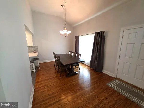 a view of a dining room with furniture and a chandelier