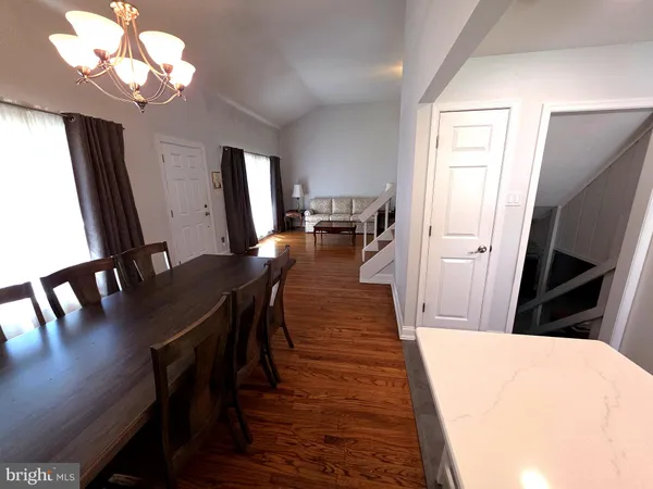 a kitchen with a table chairs and a refrigerator