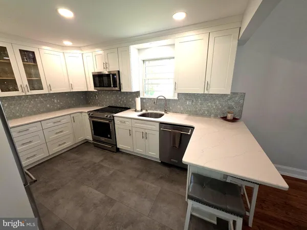 a kitchen with a refrigerator and a sink