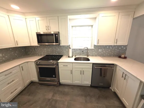 a view of kitchen with refrigerator and wooden floor
