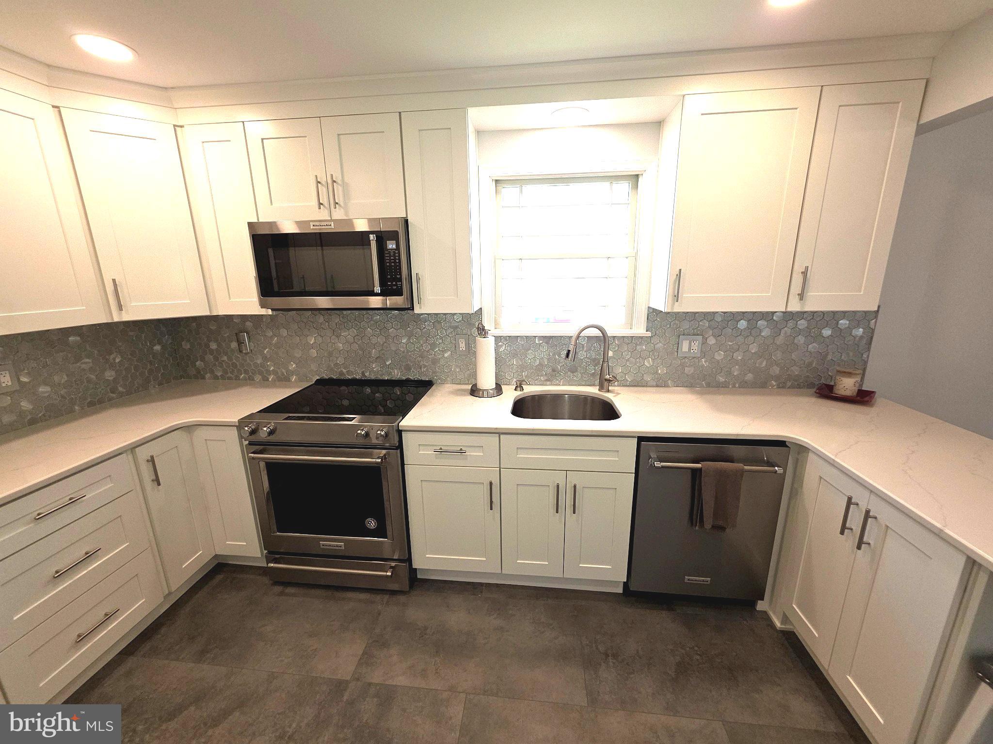 156 Crockett Road Warminster, PA 18974 - Photo 24 of 57 a kitchen with granite countertop white cabinets and white appliances