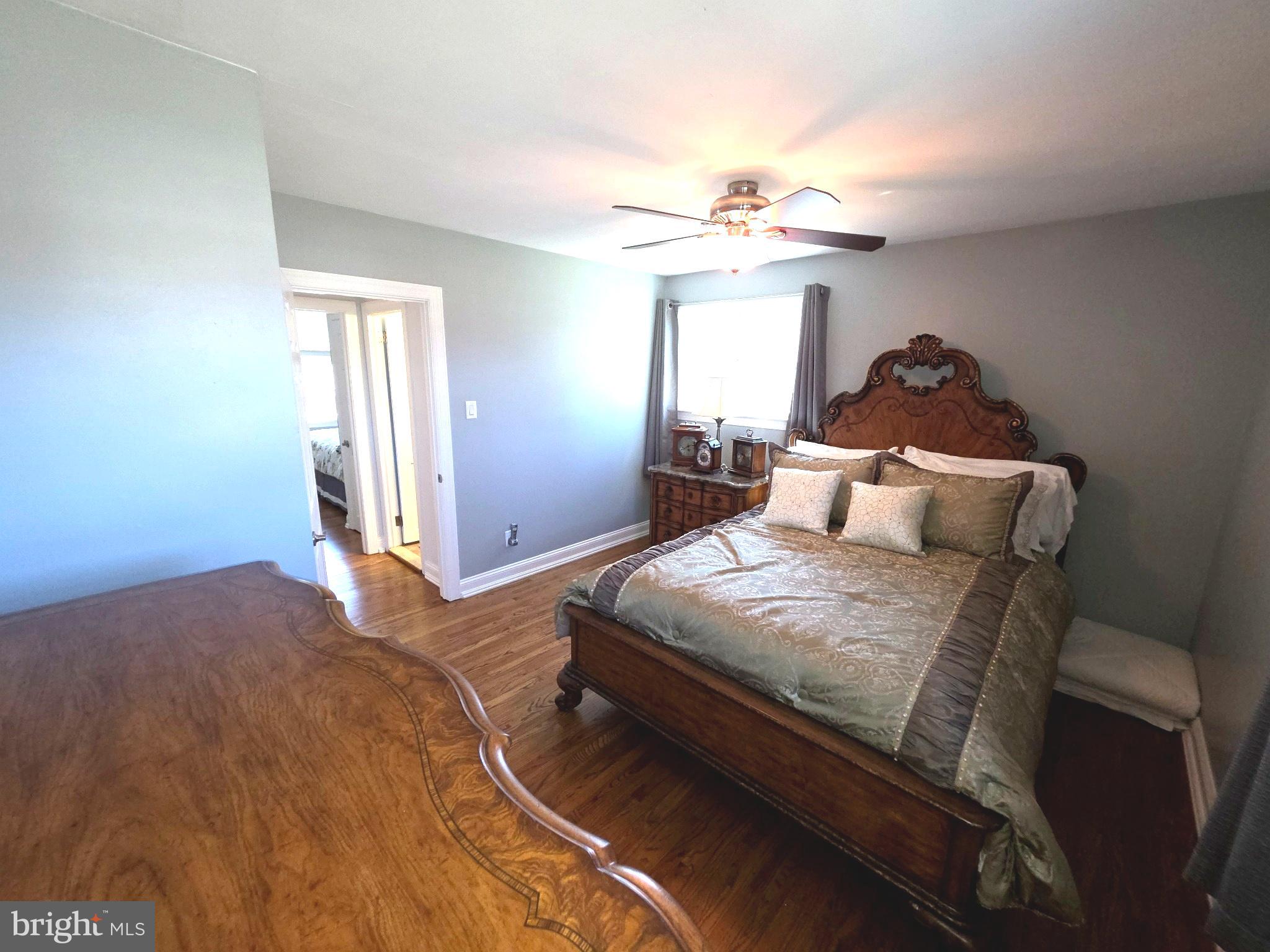 156 Crockett Road Warminster, PA 18974 - Photo 39 of 57 a bedroom with a bed and a chandelier