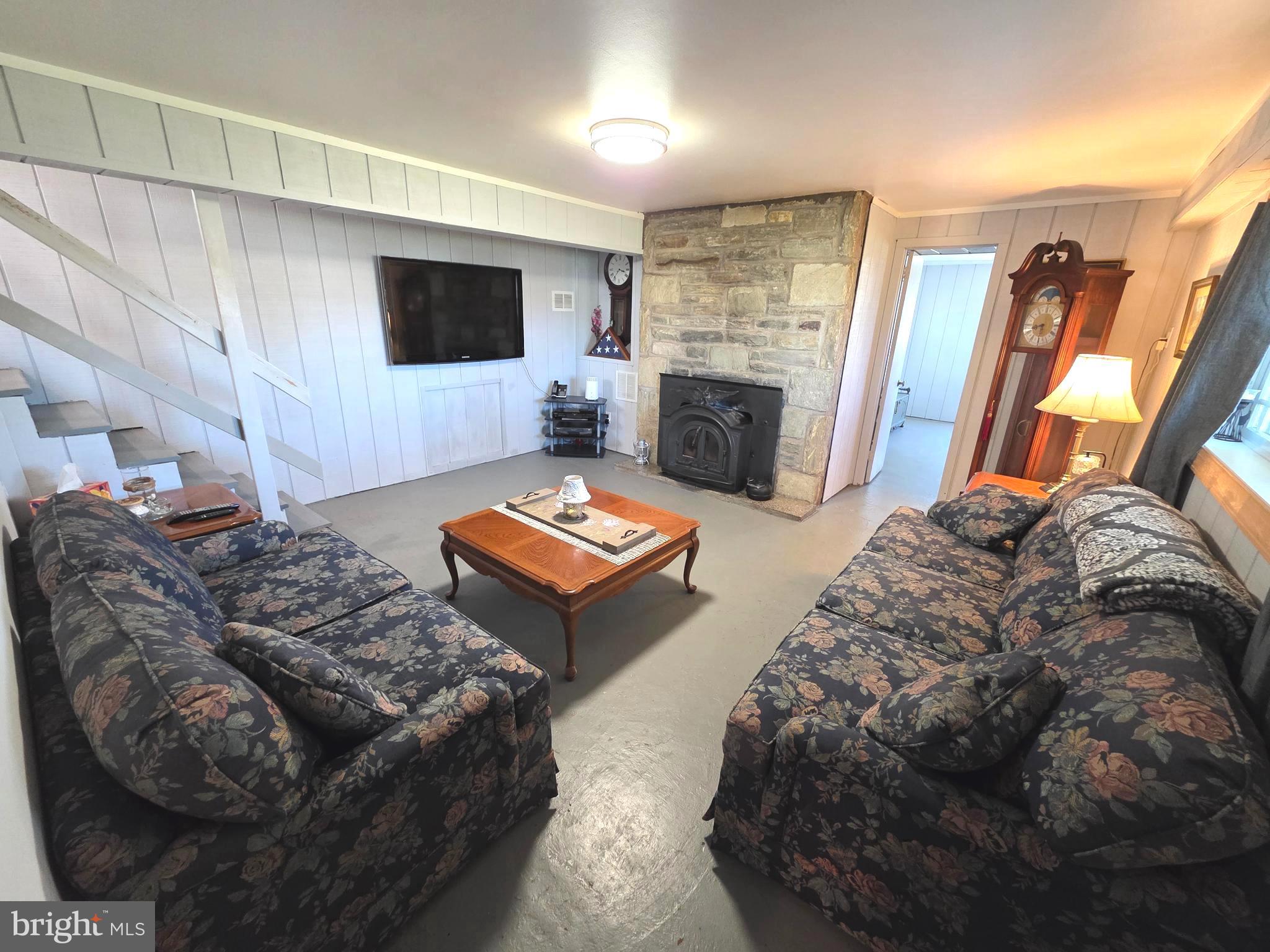 156 Crockett Road Warminster, PA 18974 - Photo 50 of 57 a living room with furniture a flat screen tv and a fireplace
