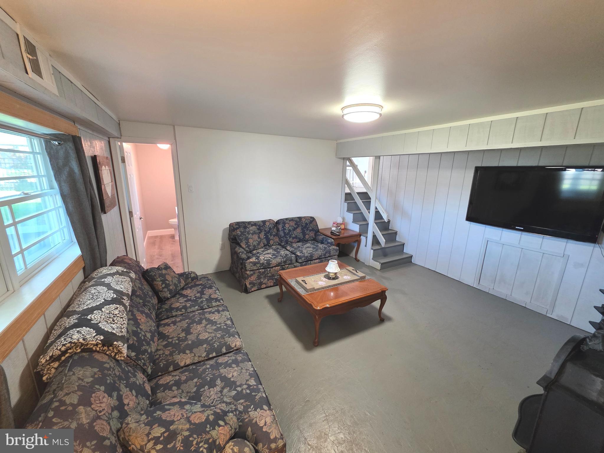 156 Crockett Road Warminster, PA 18974 - Photo 51 of 57 a living room with furniture and a flat screen tv