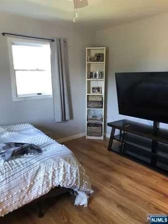 a bedroom with a bed window and a chair