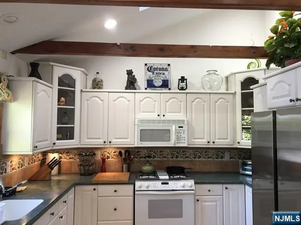 a kitchen with stainless steel appliances granite countertop a sink and a stove
