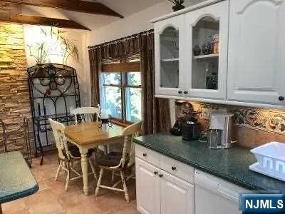 a dining table with chairs and window