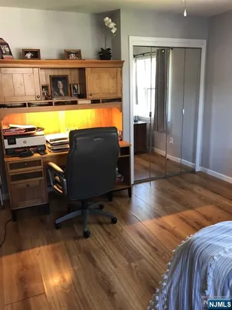a living room with a bed furniture and a window
