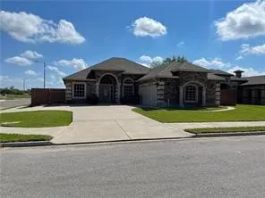 a view of a house with a yard and a garden