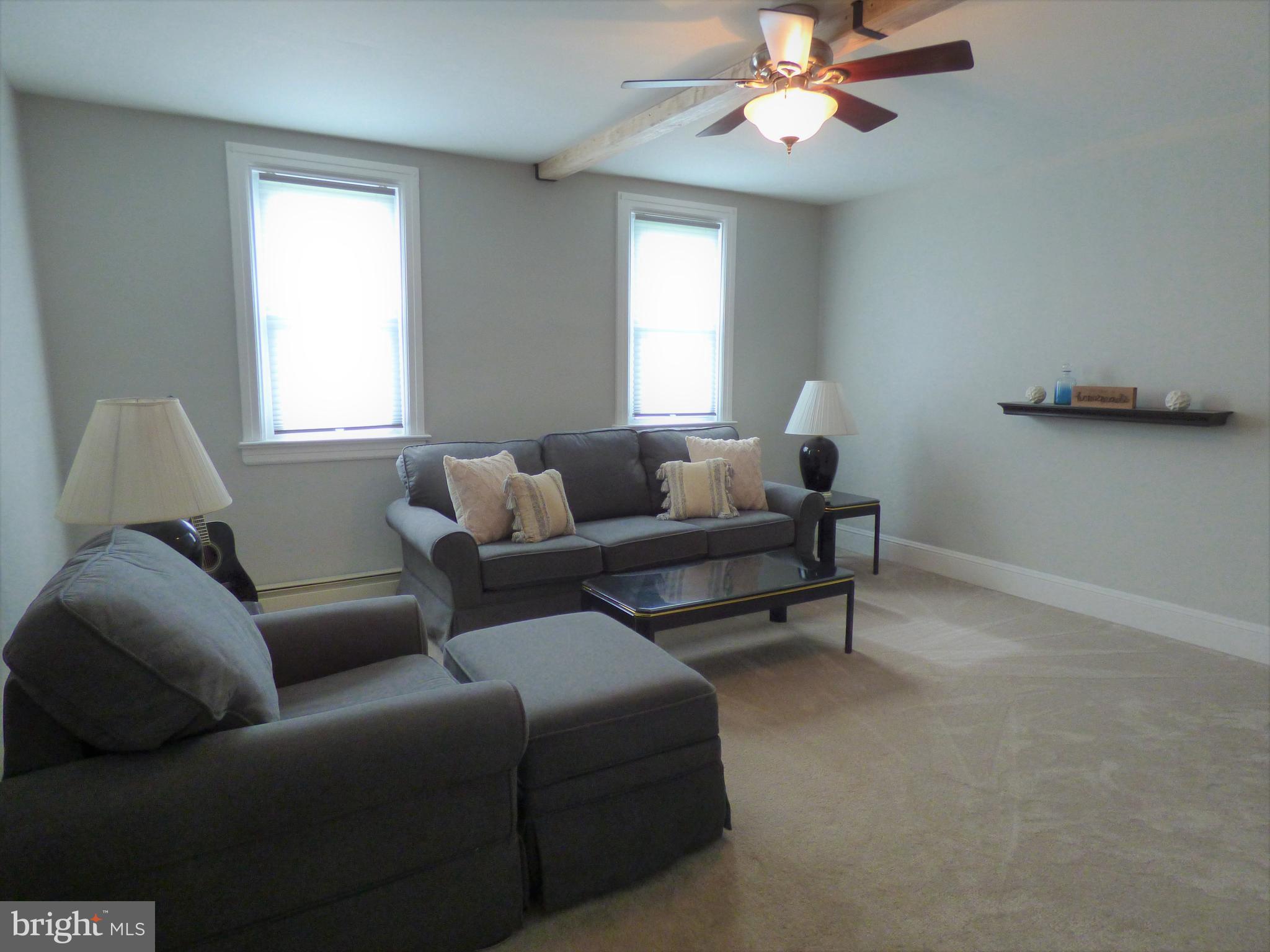 235 Reid Road Coatesville, PA 19320 - Photo 8 of 32 Living room with ceiling fan and new carpet