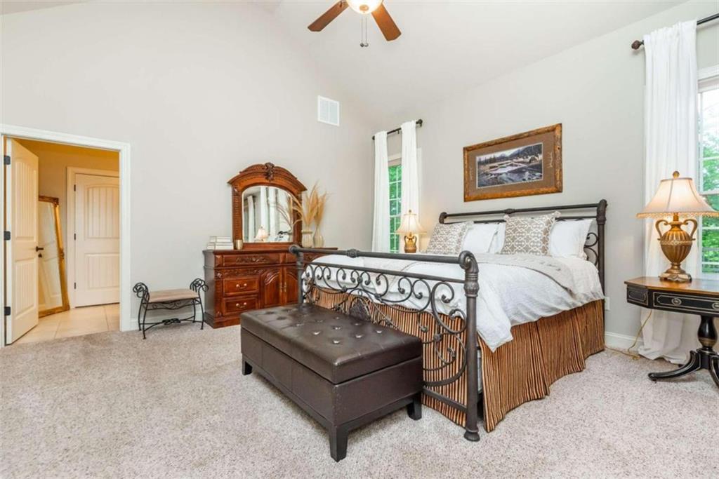 565 Owens Gin Road Northeast Calhoun, GA 30701 - Photo 46 of 80 a bedroom with a bed and a chandelier