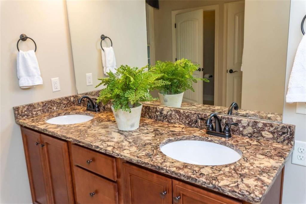 565 Owens Gin Road Northeast Calhoun, GA 30701 - Photo 48 of 80 a bathroom with a granite countertop sink and a mirror