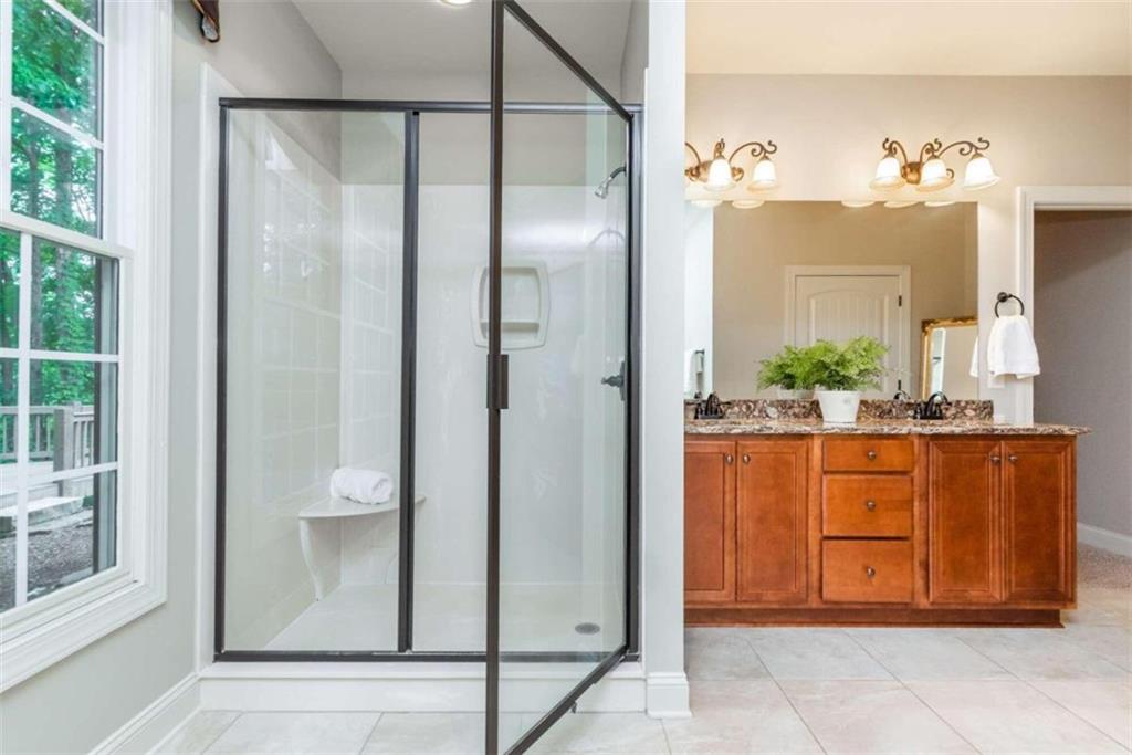 565 Owens Gin Road Northeast Calhoun, GA 30701 - Photo 49 of 80 a bathroom with a glass shower door and mirror