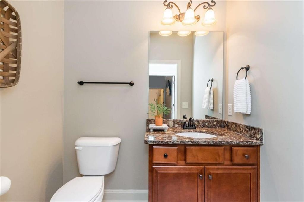 565 Owens Gin Road Northeast Calhoun, GA 30701 - Photo 51 of 80 a bathroom with a granite countertop toilet sink and mirror