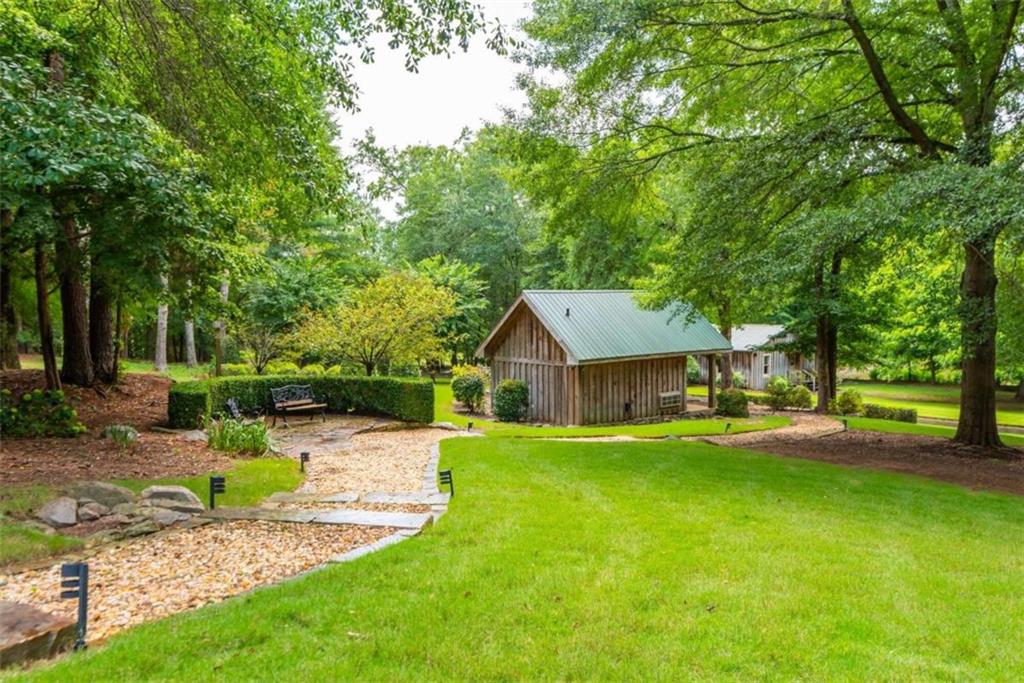 565 Owens Gin Road Northeast Calhoun, GA 30701 - Photo 64 of 80 a front view of a house with a yard garage and outdoor seating