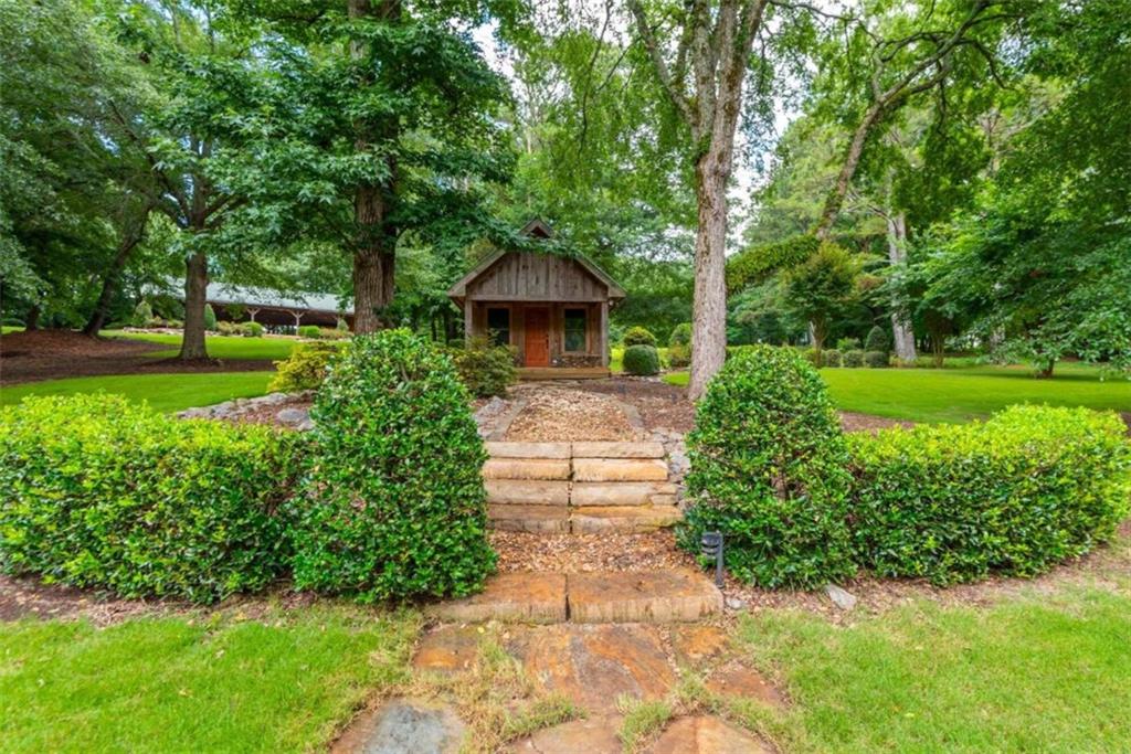565 Owens Gin Road Northeast Calhoun, GA 30701 - Photo 65 of 80 a front view of a house with garden