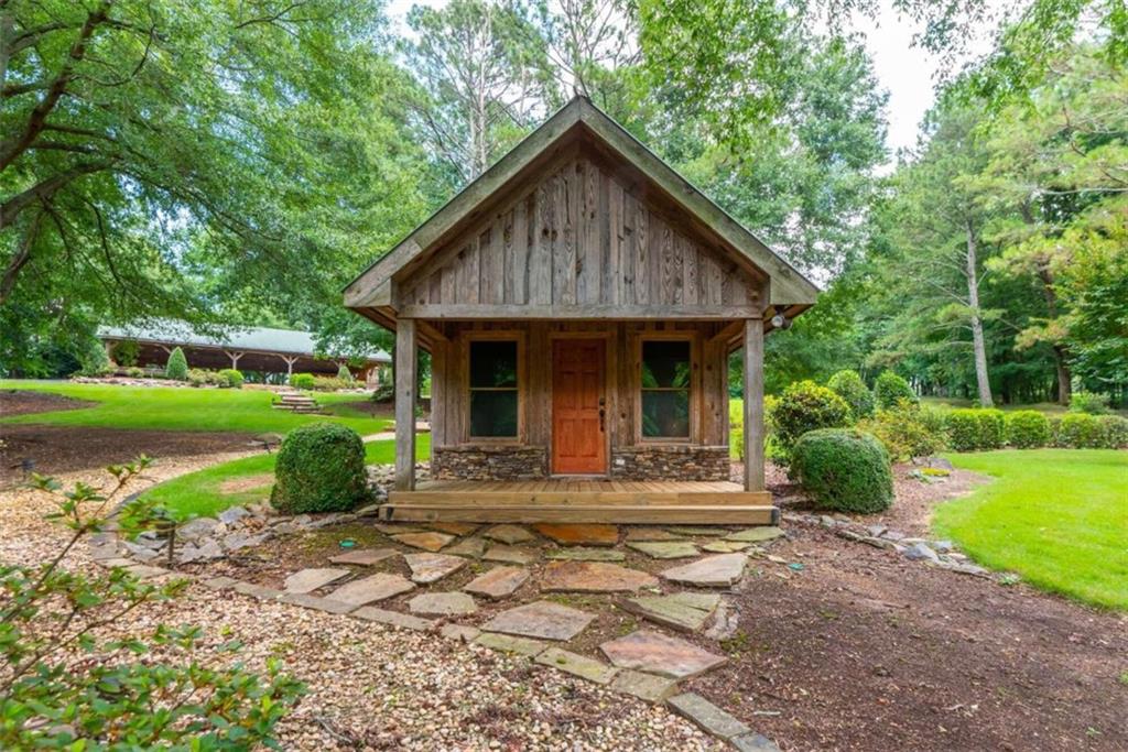 565 Owens Gin Road Northeast Calhoun, GA 30701 - Photo 66 of 80 a front view of a house with garden