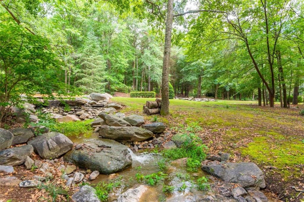 565 Owens Gin Road Northeast Calhoun, GA 30701 - Photo 71 of 80 a view of a grassy field with trees