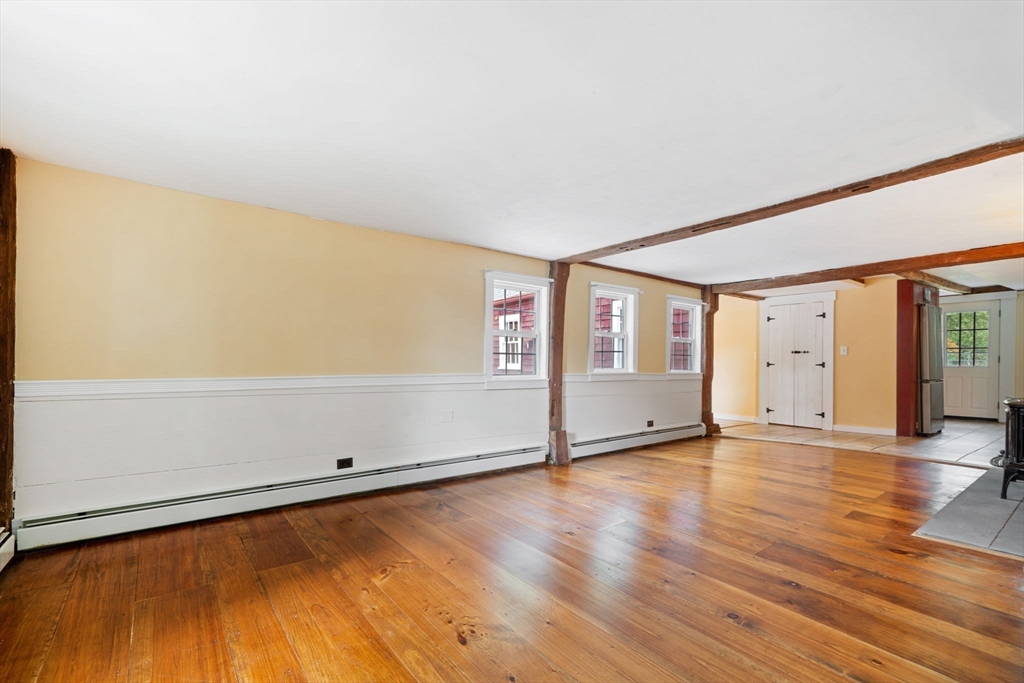 132 Maple Avenue Atkinson, NH 03811 - Photo 14 of 41 an empty room with wooden floor and windows