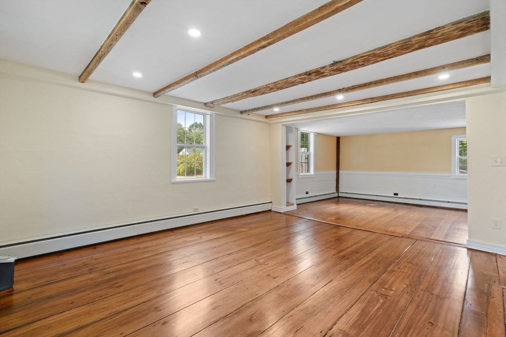 132 Maple Avenue Atkinson, NH 03811 - Photo 18 of 41 an empty room with wooden floor and windows
